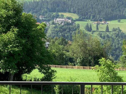 a view of a field with trees and a fence at Residence Villa Schlern in Fiè