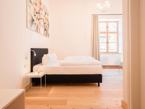 a bedroom with a bed and a table and a window at Post Berching in Berching