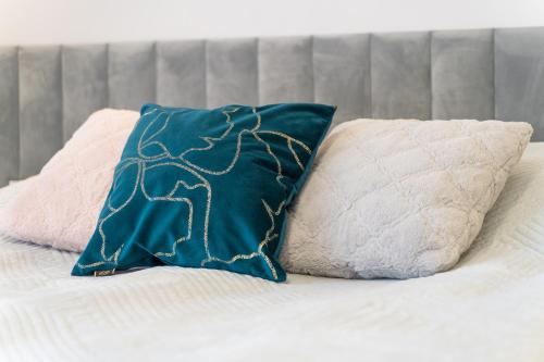 a bed with two pillows on top of it at Silver Apartments in Świnoujście