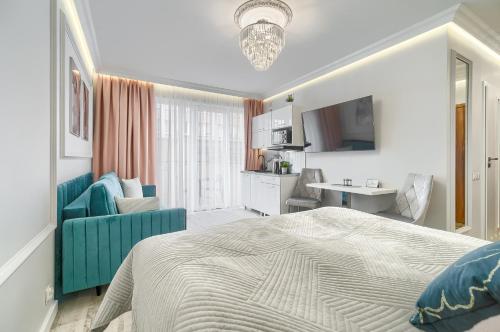 a bedroom with a bed and a living room at Silver Apartments in Świnoujście