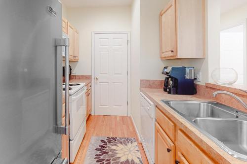 a kitchen with a sink and a refrigerator at Eagles Landing - 4300 Sandpiper #4314 in Rehoboth Beach