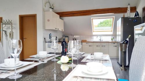a kitchen with a table with wine glasses on it at Wohnung Famous, 100qm, Klima, Loggia, 24h Checkin, bis 5 Personen in Braunschweig