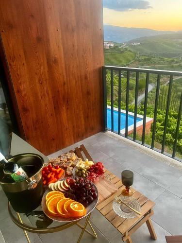 a tray of food on a table on a balcony at Casa do Romezal in Peso da Régua
