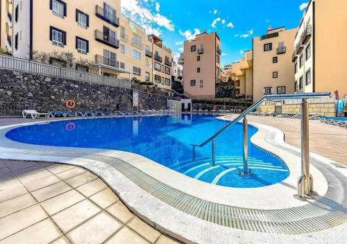 a swimming pool in the middle of a building at Chilly Apartment - Sunny rooftop terrace with ocean view in Callao Salvaje