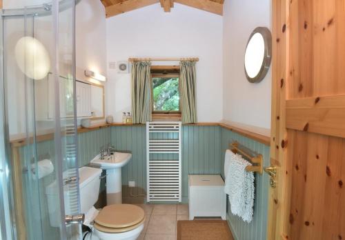 a bathroom with a toilet and a sink at Chapel House in Torridon
