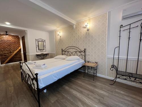 a bedroom with a bed and a mirror on the wall at Hotel Boutique Cathedral Plaza Residences room for rent downtown in Bucharest