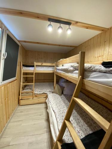 a small room with three bunk beds in it at Domek Wakacyjny Maciuś 48 in Głębokie