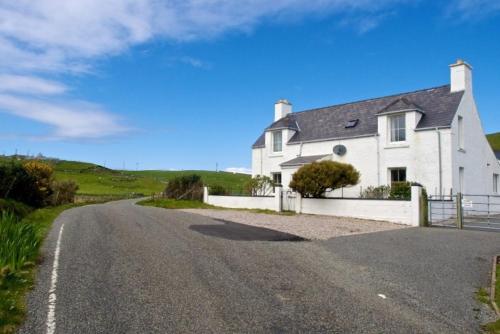 a house on the side of a road at 7A Ardroil in Uig
