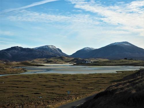 a view of a river with mountains in the background at 7A Ardroil in Uig