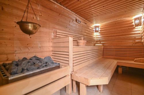 a wooden sauna with a bench and a light at Apart-Hotel Onegin & Thermal Zone in Sozopol