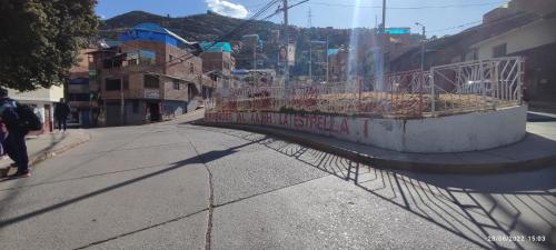 a street with a fence on the side of the road at Anacondor Guests House in Cusco