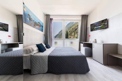 Ένα ή περισσότερα κρεβάτια σε δωμάτιο στο Hotel Canarino