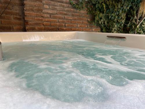 a jacuzzi tub filled with lots of water at Verde Madera Hostel B&B in Santiago
