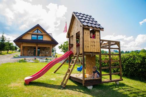 a child playing on a slide in a play house at Domek "PRZYBYSZÓWKA" Bieszczady in Mchawa