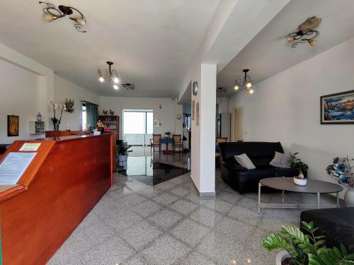 a living room with a couch and a table at Hotel Odyssion in Vasiliki