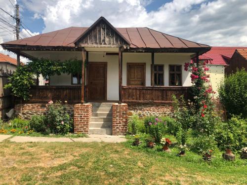 a small white house with a red roof at Old Court in Curtea de Argeş