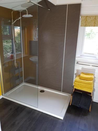 a shower with a glass enclosure in a bathroom at The Old Potting Shed with hot tub. Colan, Newquay. in Newquay