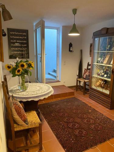 a room with a table with a vase of flowers on it at Ferienwohnung Nedwed in Pörtschach am Wörthersee