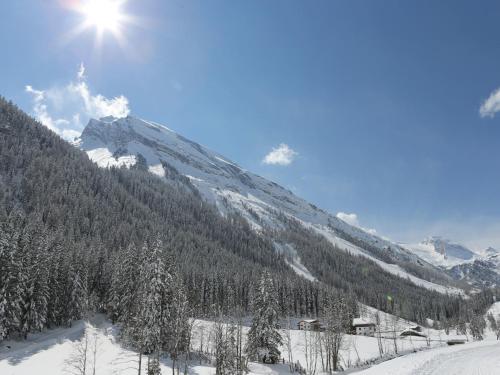 a snow covered mountain with the sun shining on it at Gasthof Pension Madseiterhof in Tux