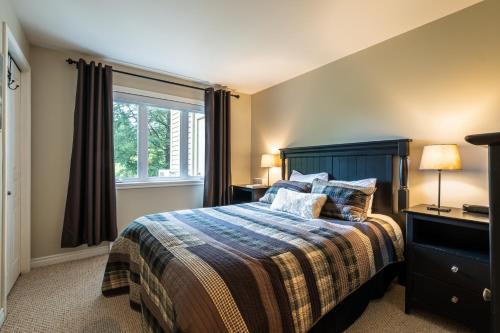 a bedroom with a bed and a window at Aiglon by Rendez-Vous Mont-Tremblant in Mont-Tremblant