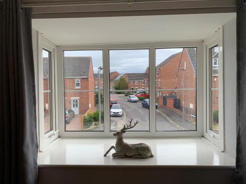 a statue of a deer sitting on a window sill at Craven Cottage in Northallerton
