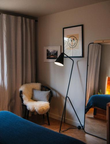 a bedroom with a floor lamp and a chair at Apres Whitefish in Whitefish
