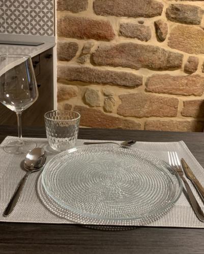 a glass plate on a table with a wine glass at Mar De Muros in Muros
