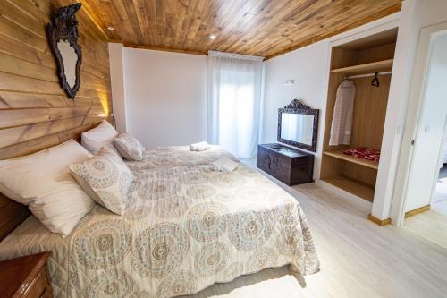 a bedroom with a bed and a television in it at La Casona 1930 in Mazaricos