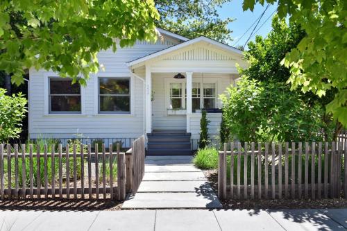 a white house with a fence in front of it at Fitch St Escape A Wine Country Escape in Healdsburg