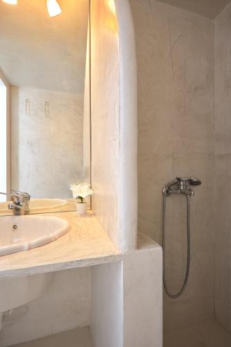 a bathroom with a sink and a shower at Family Maisonette with pool #4 in Nea Fokea
