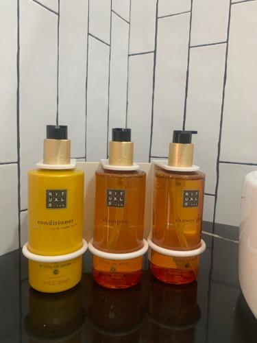 a group of three bottles of honey on a shelf at Mar De Muros in Muros