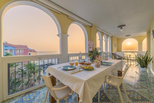 a dining room with a table on a balcony at DOLF - Attico sul Mare in Porto Recanati
