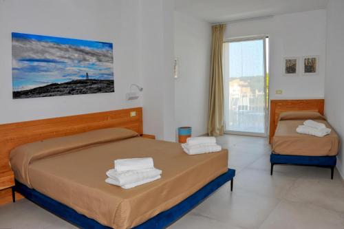 A bed or beds in a room at BluOtranto