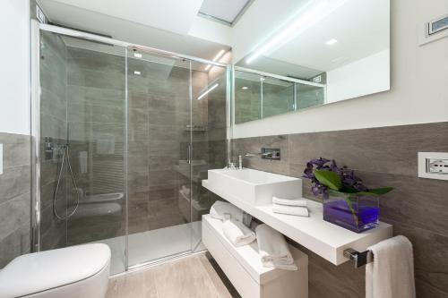 a bathroom with a sink and a shower at Verona Suites in Verona
