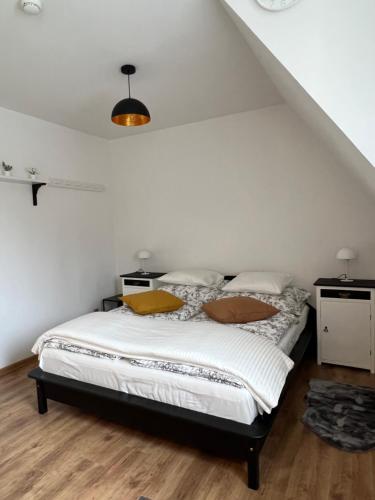 a bedroom with a bed with white sheets at Resort LUFT Sněžník in Sněžnik