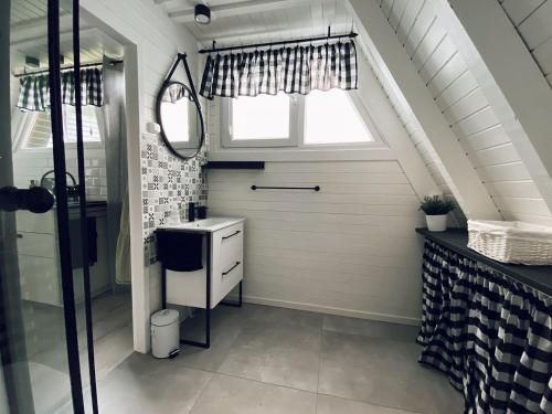 a bathroom with a sink and a window at Domek Letniskowy Dario in Ińsko