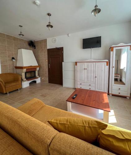 a living room with a couch and a flat screen tv at Resort LUFT Sněžník in Sněžnik