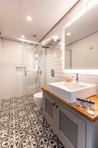 a bathroom with a sink and a toilet at Yerli Alaçatı in Alaçatı