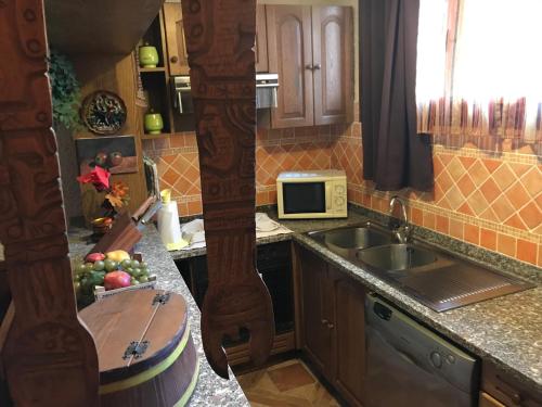 a kitchen with a sink and a bowl of fruit on the counter at Casa Vacanze Neri in Scandicci