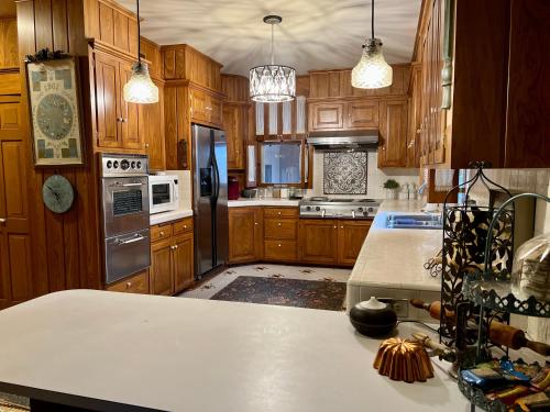 a kitchen with wooden cabinets and a white counter top at THE CW HOUSE in Claude