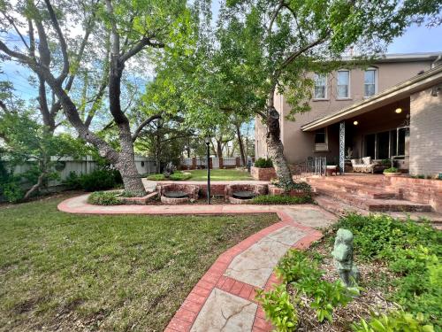 a garden with trees and a brick walkway at THE CW HOUSE in Claude