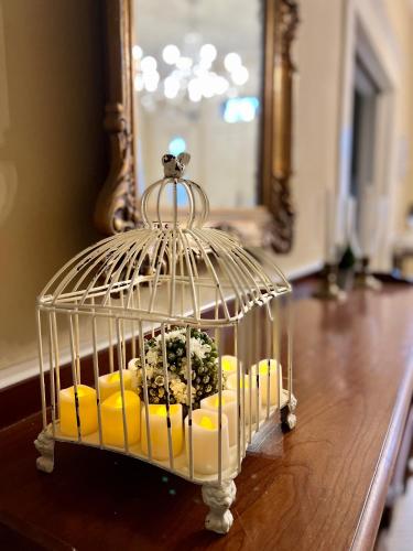 a bird cage with food in it on a table at THE CW HOUSE in Claude
