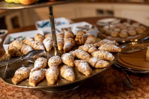 a tray of muffins and donuts on a table at Hotel Finkennest - Panoramic Garden Resort in Schenna