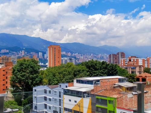 a view of a city with buildings and mountains at Neim Platinum Hotel in Medellín