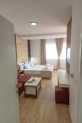 a hotel room with a bed and a living room at RIBAR APARTMENTS in Ohrid