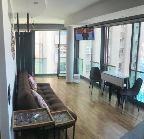 a living room with a couch and a table and a piano at Apartamento Rosario 2 in Vigo
