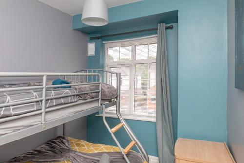a bunk bed in a room with a window at Leeds city centre spacious house free parking and Wi-Fi in Leeds