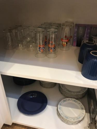 a white shelf with jars and plates on it at Apartament Ko-Piernika w Toruniu, w Sercu toruńskiej Starówki in Toruń