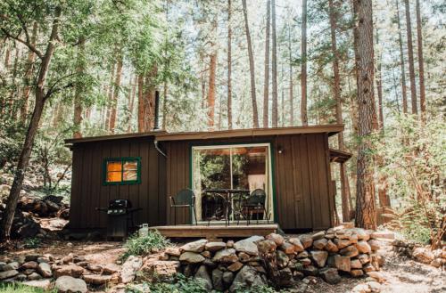 a small cabin in the woods with trees at The Don Hoel Resort & Venue in Sedona