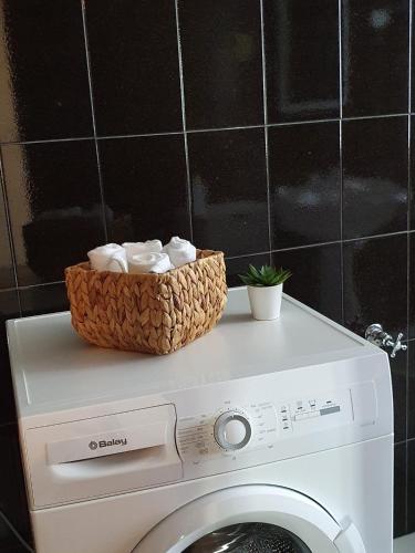 a washing machine with a basket on top of it at Casa do Cruzeiro in Aguiar da Beira